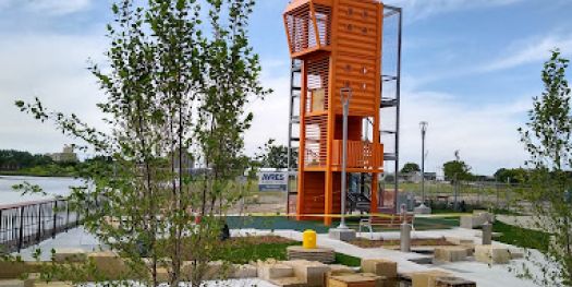 A whimsical children's play structure, designed with input from Design Department, features water play elements and encourages exploration.